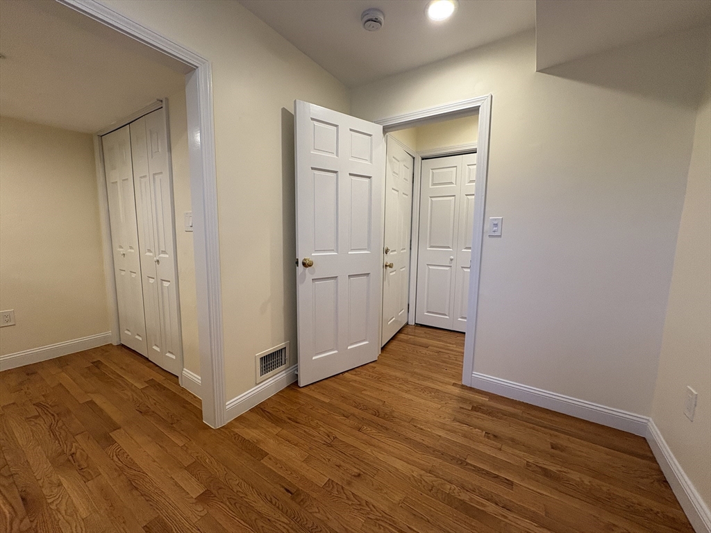 1801 Beacon Street, Unit 1 Brookline, MA 02445 - Photo 14 of 14 a view of an empty room with wooden floor