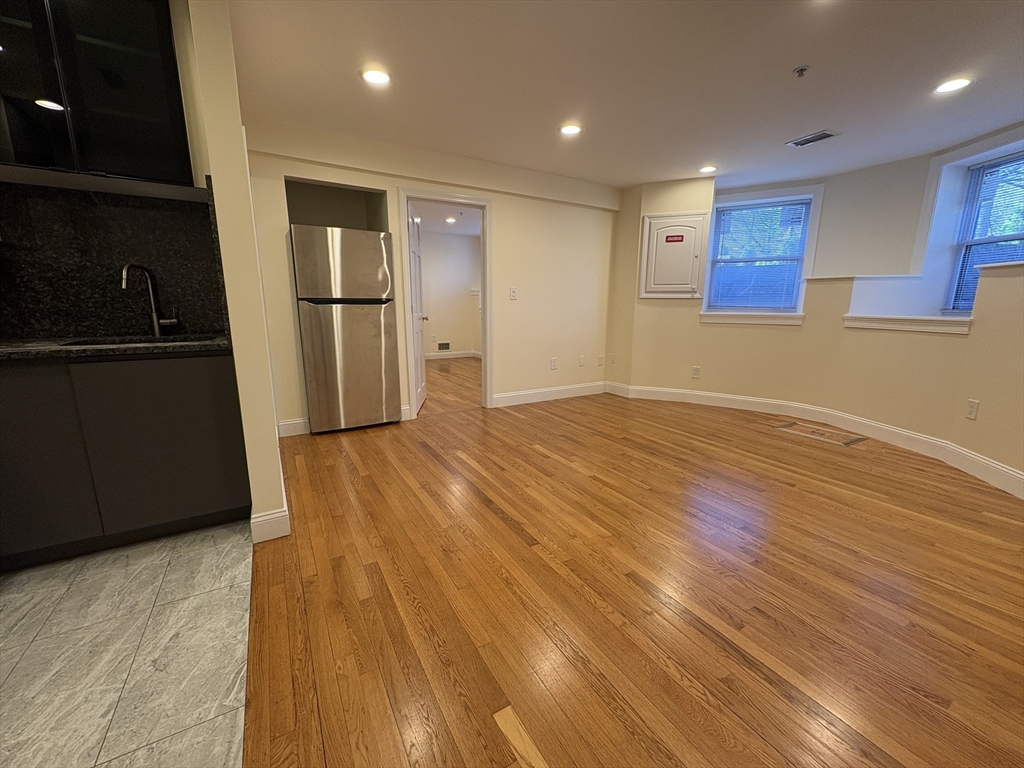 1801 Beacon Street, Unit 1 Brookline, MA 02445 - Photo 4 of 14 a view of empty room with wooden floor