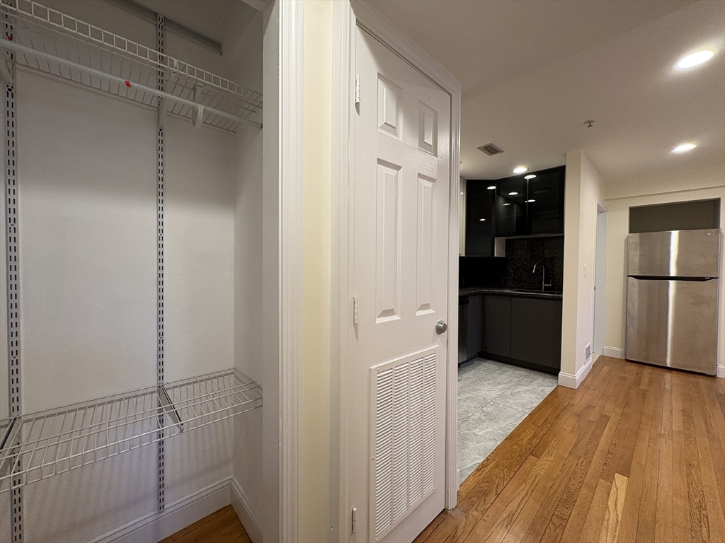 1801 Beacon Street, Unit 1 Brookline, MA 02445 - Photo 5 of 14 a view of hallway with wooden floor