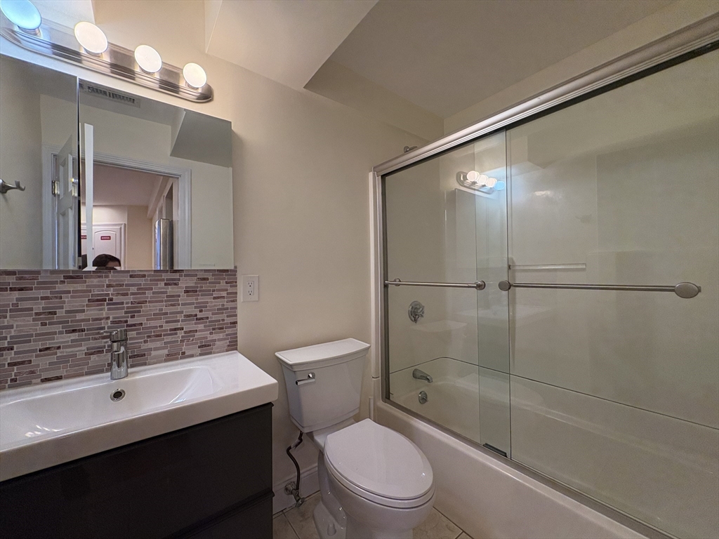 1801 Beacon Street, Unit 1 Brookline, MA 02445 - Photo 6 of 14 a bathroom with a sink a toilet and shower