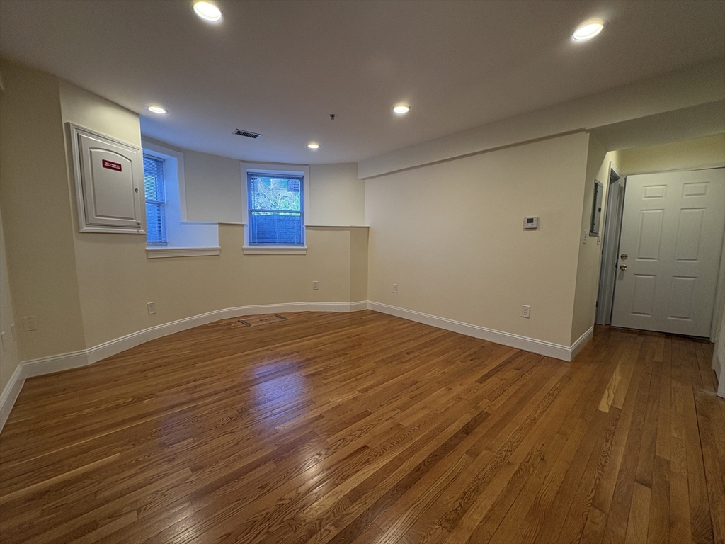 1801 Beacon Street, Unit 1 Brookline, MA 02445 - Photo 8 of 14 a view of empty room with wooden floor