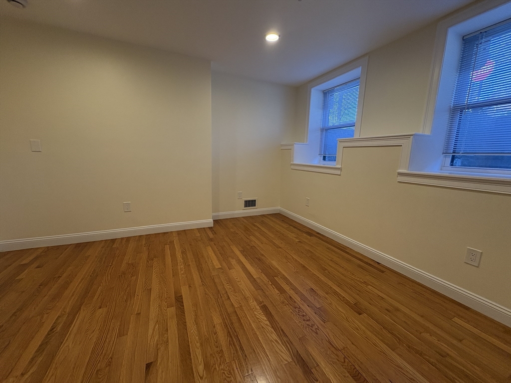 1801 Beacon Street, Unit 1 Brookline, MA 02445 - Photo 9 of 14 a view of empty room with wooden floor