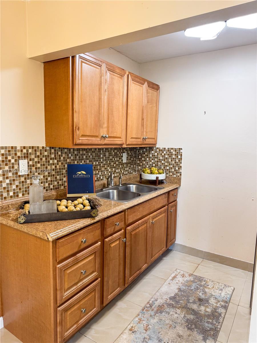 2145 Pierce Street, Unit 118 Hollywood, FL 33020 - Photo 8 of 18 a bathroom with a granite countertop sink and a window