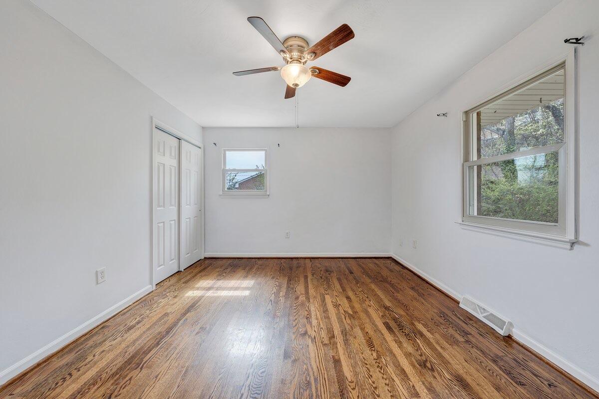 756 Kenyon Road Vinton, VA 24179 - Photo 4 of 14 an empty room with wooden floor and windows