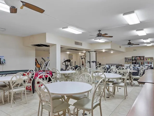 a view of a dining room with furniture and a chandelier