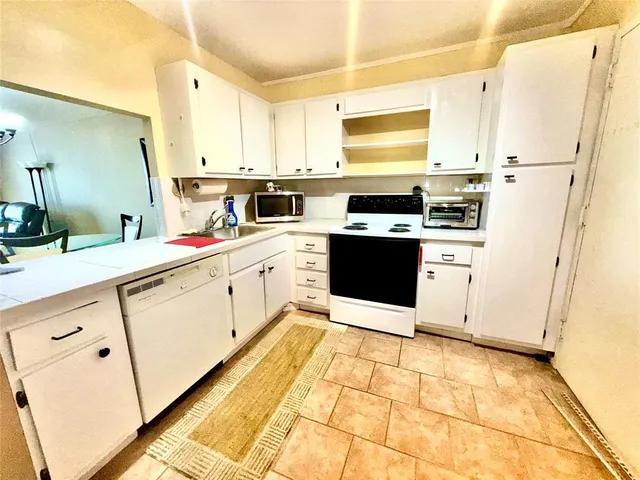 a kitchen with stainless steel appliances a stove refrigerator sink and cabinets