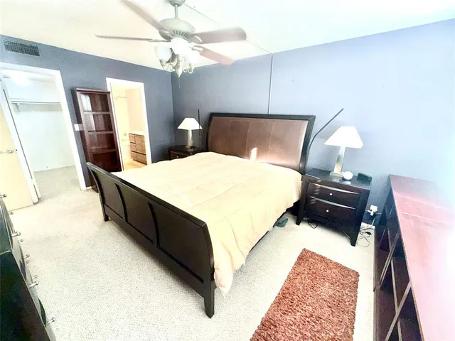 a bed sitting in a bedroom with a tv