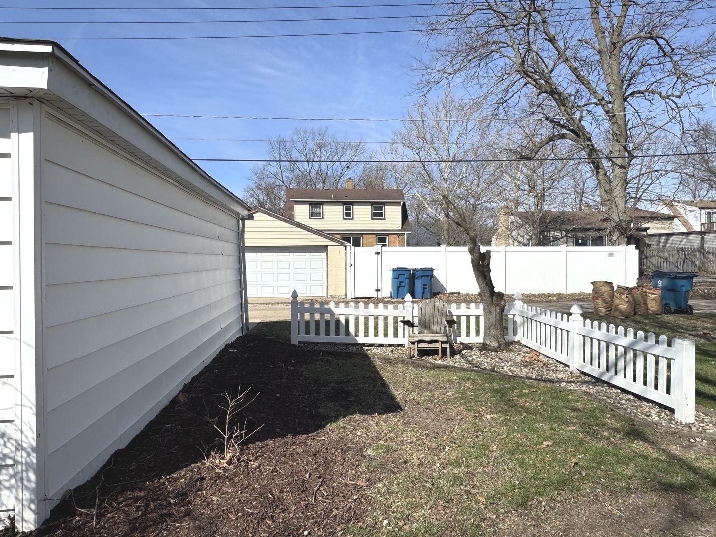 665 South May Avenue Kankakee, IL 60901 - Photo 18 of 22 a view of a porch with wooden fence and a bench