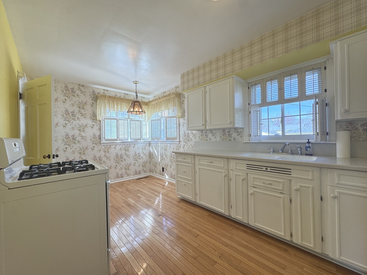 665 South May Avenue Kankakee, IL 60901 - Photo 8 of 22 a kitchen with kitchen island granite countertop a sink cabinets and wooden floor