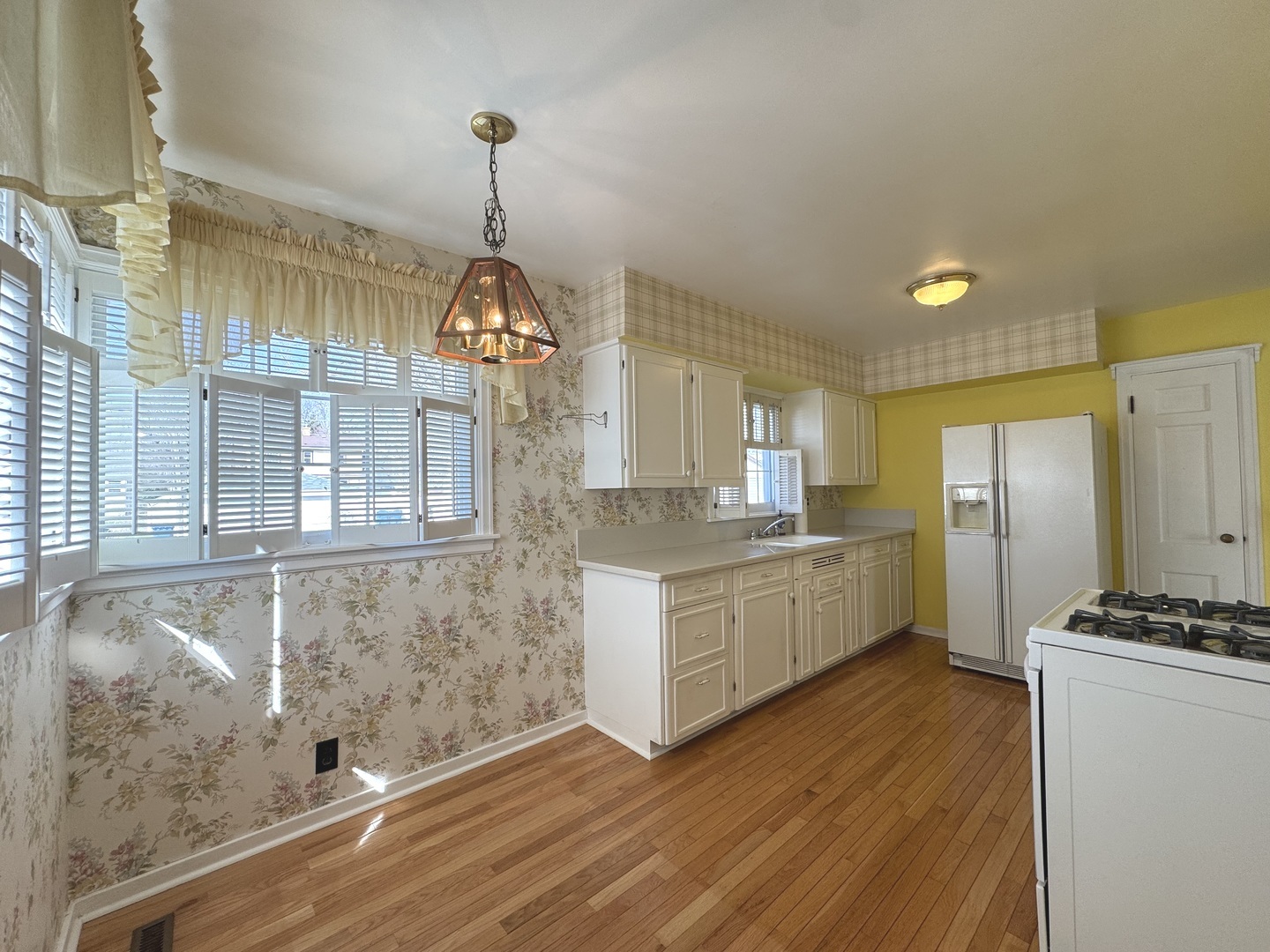 665 South May Avenue Kankakee, IL 60901 - Photo 9 of 22 a kitchen with stainless steel appliances granite countertop a stove a sink dishwasher and a refrigerator with white cabinets