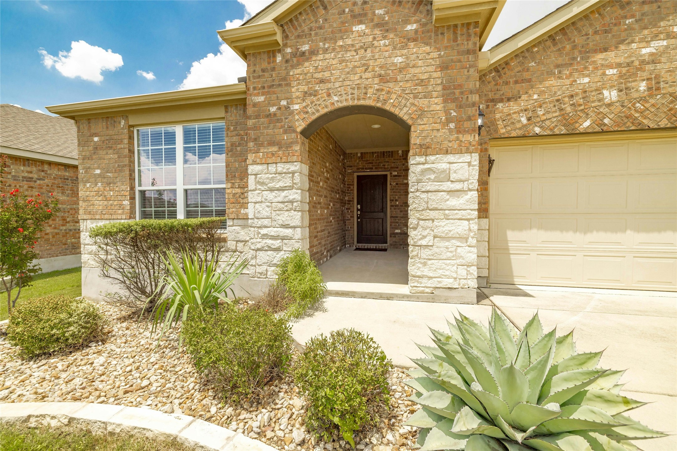 203 Longview Lane Georgetown, TX 78633 - Photo 3 of 37 a front view of a house with a garden