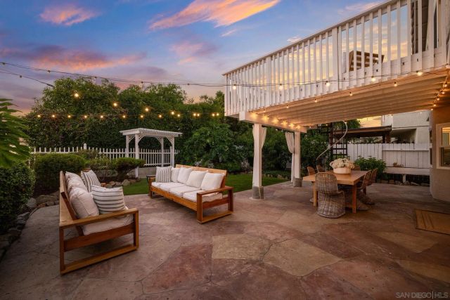 a view of a patio with a table and chairs