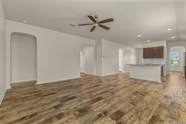 a view of kitchen with microwave a stove top oven and cabinets