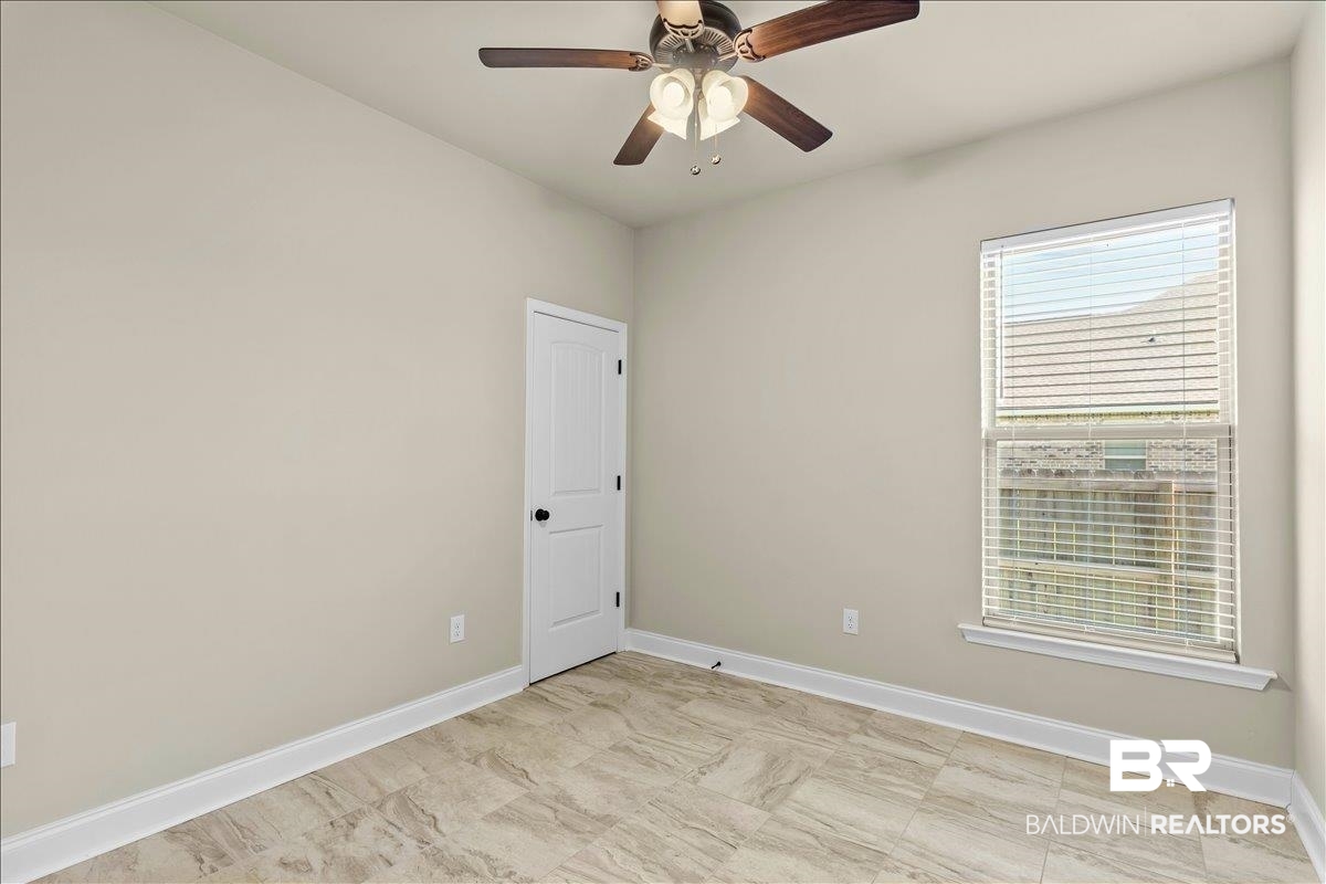 1112 Stella Road Foley, AL 36535 - Photo 17 of 33 Unfurnished room with baseboards and ceiling fan