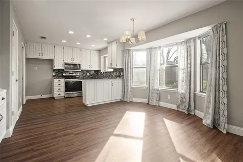a kitchen with stainless steel appliances granite countertop a stove and a refrigerator