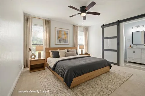 a bedroom with a large bed and a window
