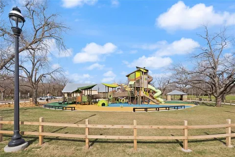 a front view of a building with trees