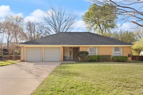 a front view of house with yard and trees