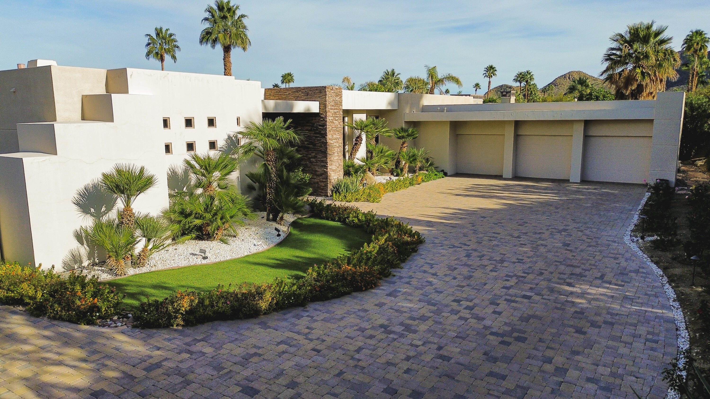 70421 Placerville Road Rancho Mirage, CA 92270 - Photo 1 of 2 a view of a white house with a yard and plants