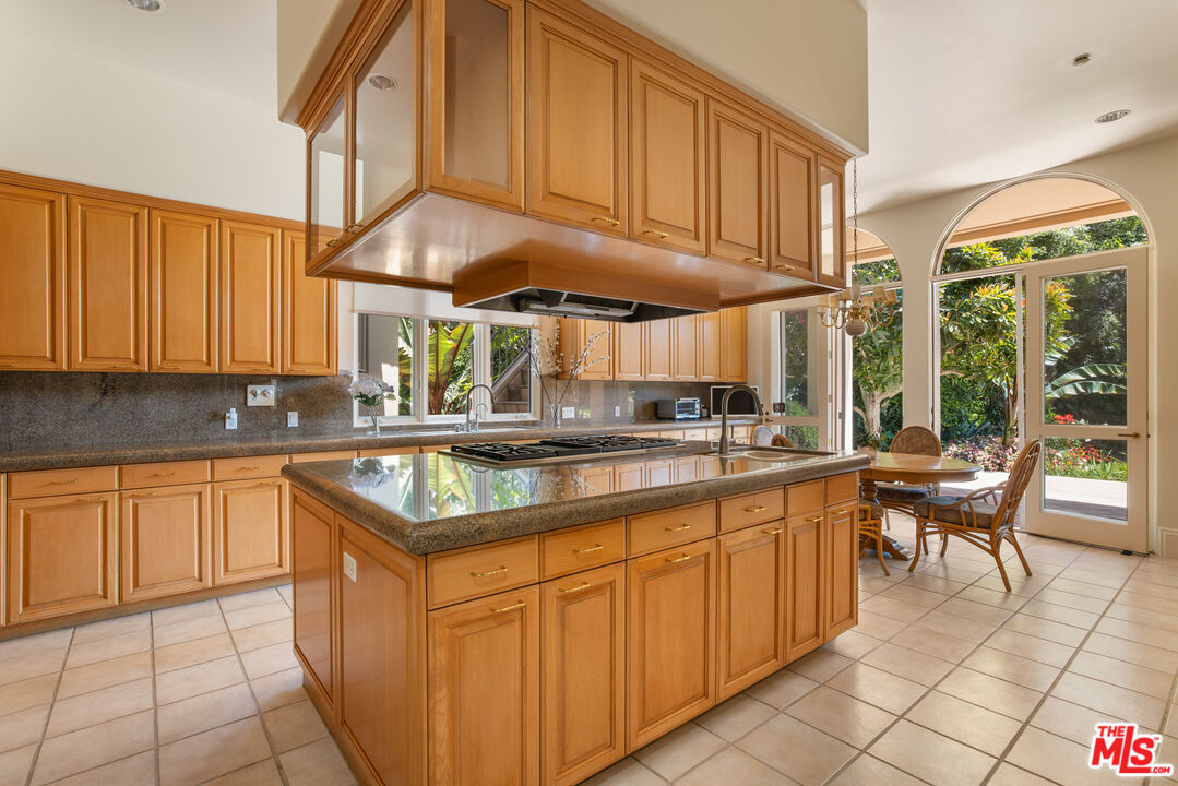 510 Doheny Road Beverly Hills, CA 90210 - Photo 13 of 24 a kitchen with stainless steel appliances granite countertop a sink and a white cabinets