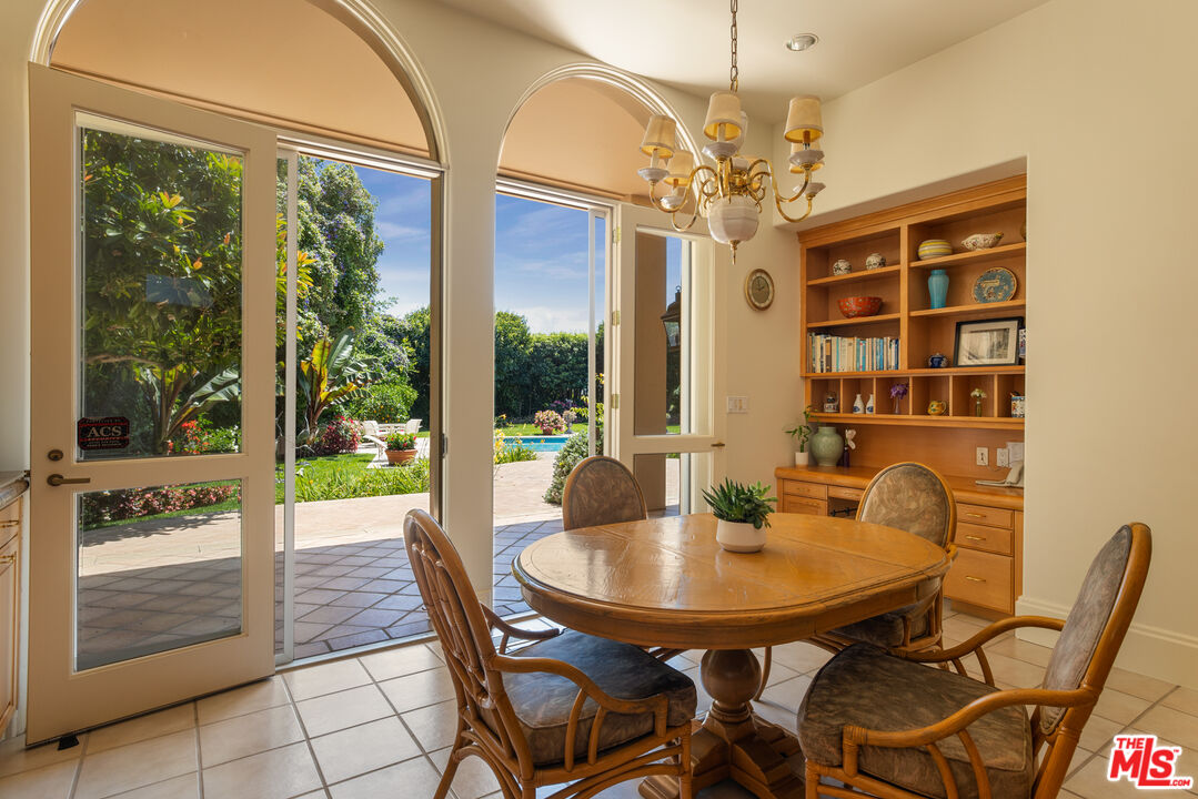 510 Doheny Road Beverly Hills, CA 90210 - Photo 14 of 24 a view of a dining room with furniture and chandelier