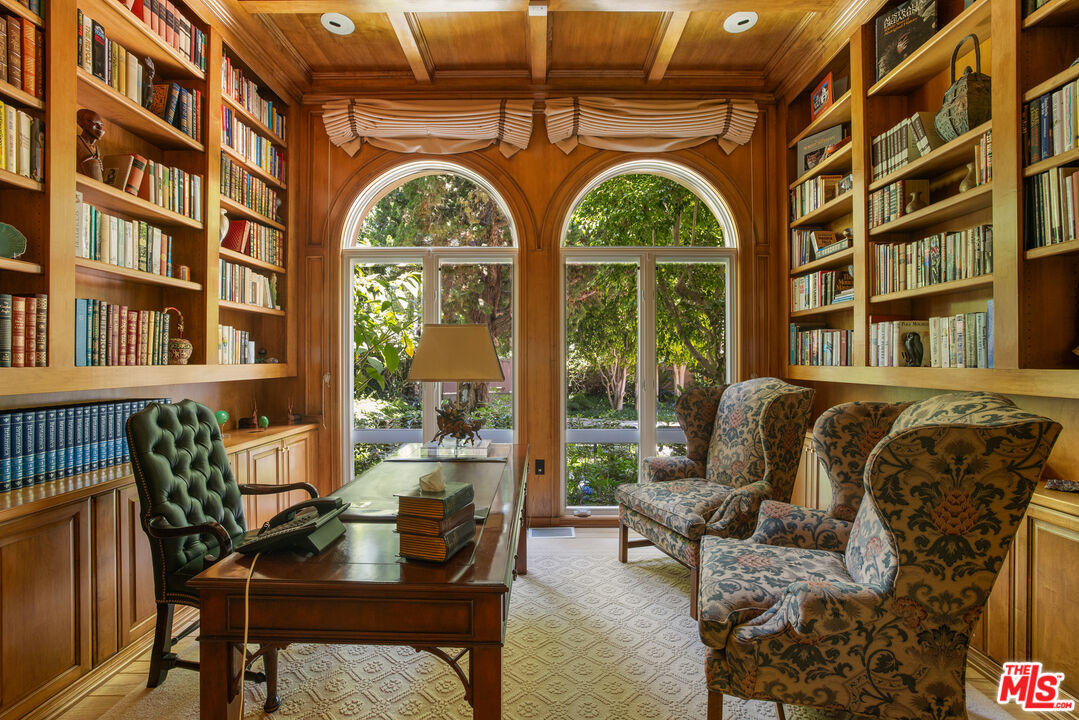 510 Doheny Road Beverly Hills, CA 90210 - Photo 15 of 24 a living room with a couch and a large window