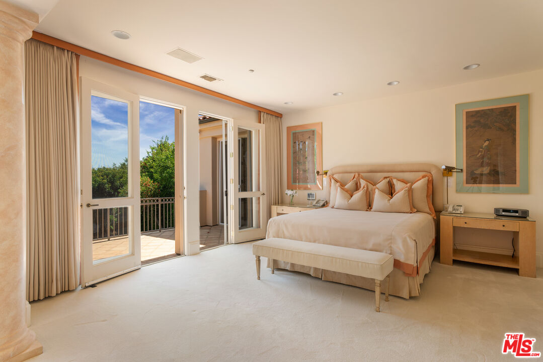 510 Doheny Road Beverly Hills, CA 90210 - Photo 17 of 24 a spacious bedroom with a large bed and a balcony view