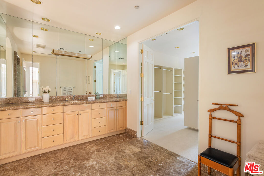 510 Doheny Road Beverly Hills, CA 90210 - Photo 20 of 24 a spacious bathroom with a shower sink and mirror