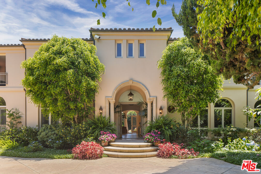 510 Doheny Road Beverly Hills, CA 90210 - Photo 2 of 24 a front view of a house with a garden