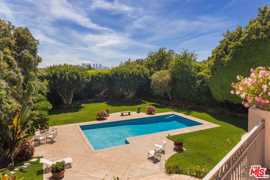510 Doheny Road Beverly Hills, CA 90210 - Photo 24 of 24 a view of swimming pool with a yard and green space