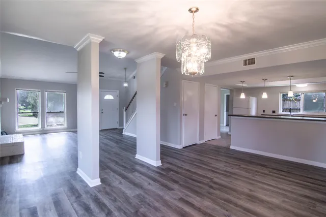 a view of a room with wooden floor and windows