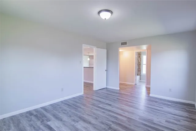 a view of an empty room and wooden floor