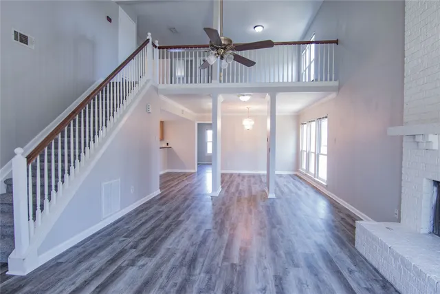 a view of staircase and kitchen with wooden floor