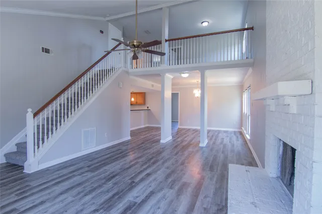 a view of staircase with wooden floor and a fireplace