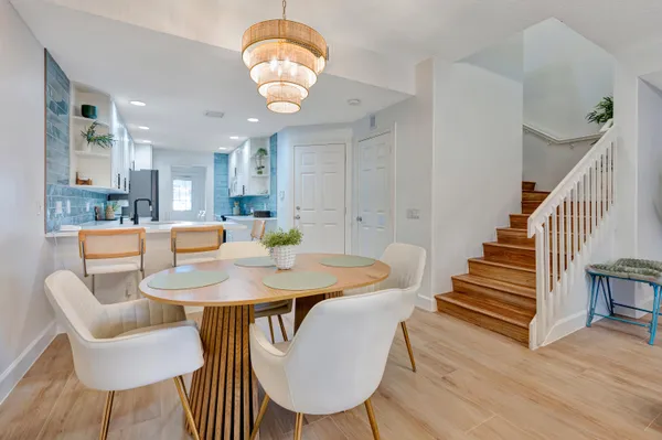 a view of a dining room with furniture and wooden floor