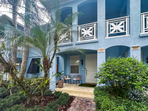 a front view of a house with outdoor seating and plants