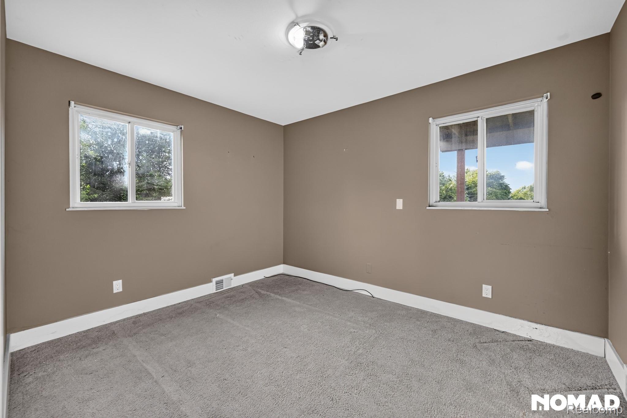 8315 Hilton Road Brighton, MI 48114 - Photo 11 of 26 Neutral-toned walls complement the gray carpeting