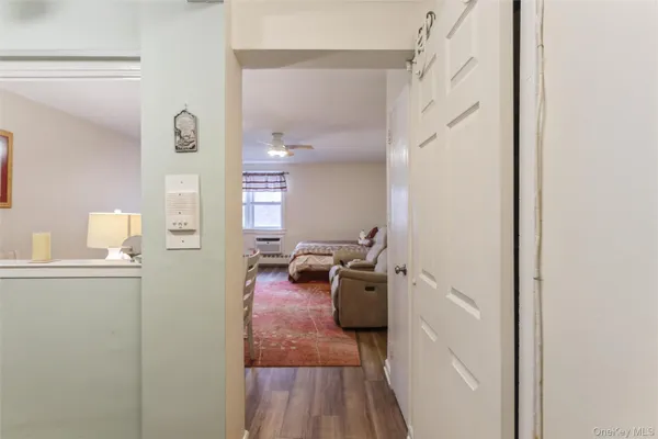 a view of a hallway with couch and wooden floor