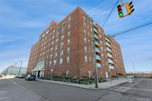 a view of a tall building next to a road