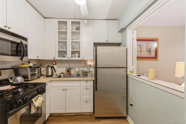a kitchen with a refrigerator stove and sink