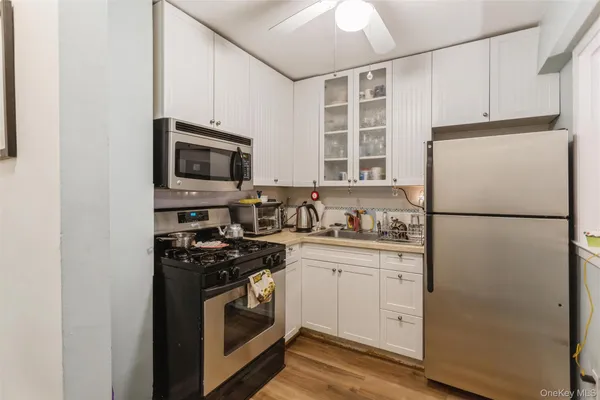a kitchen with stainless steel appliances a refrigerator sink and microwave