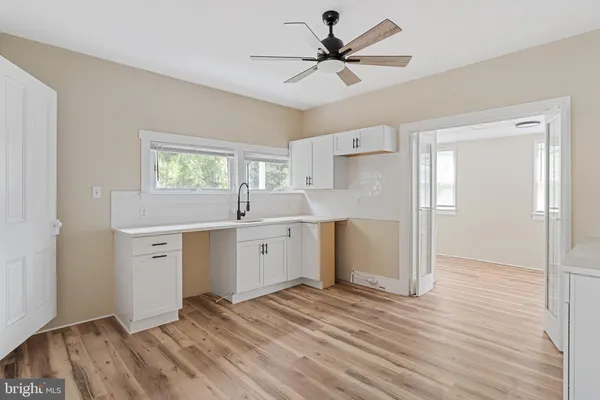 a view of a kitchen with a sink and a window