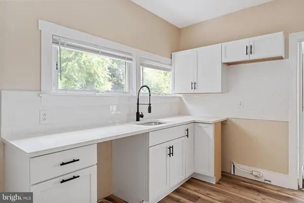 a kitchen with a sink cabinets appliances and a window