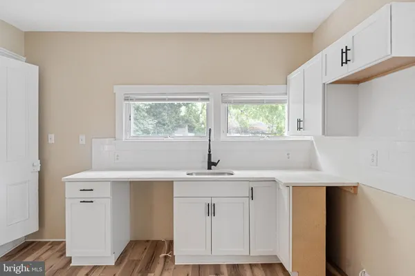 a kitchen with a sink cabinets and window