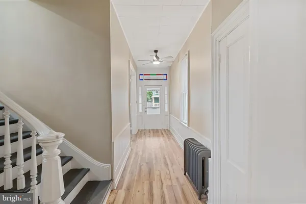 a view of entryway with stairs and wooden floor