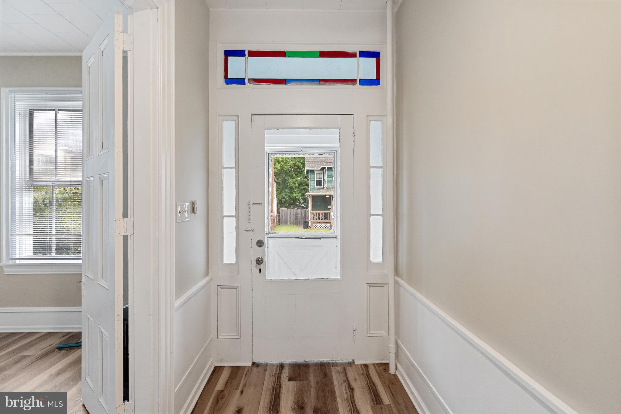 154 7th Street Salem, NJ 08079 - Photo 2 of 48 a hallway with a white cabinet door and front door