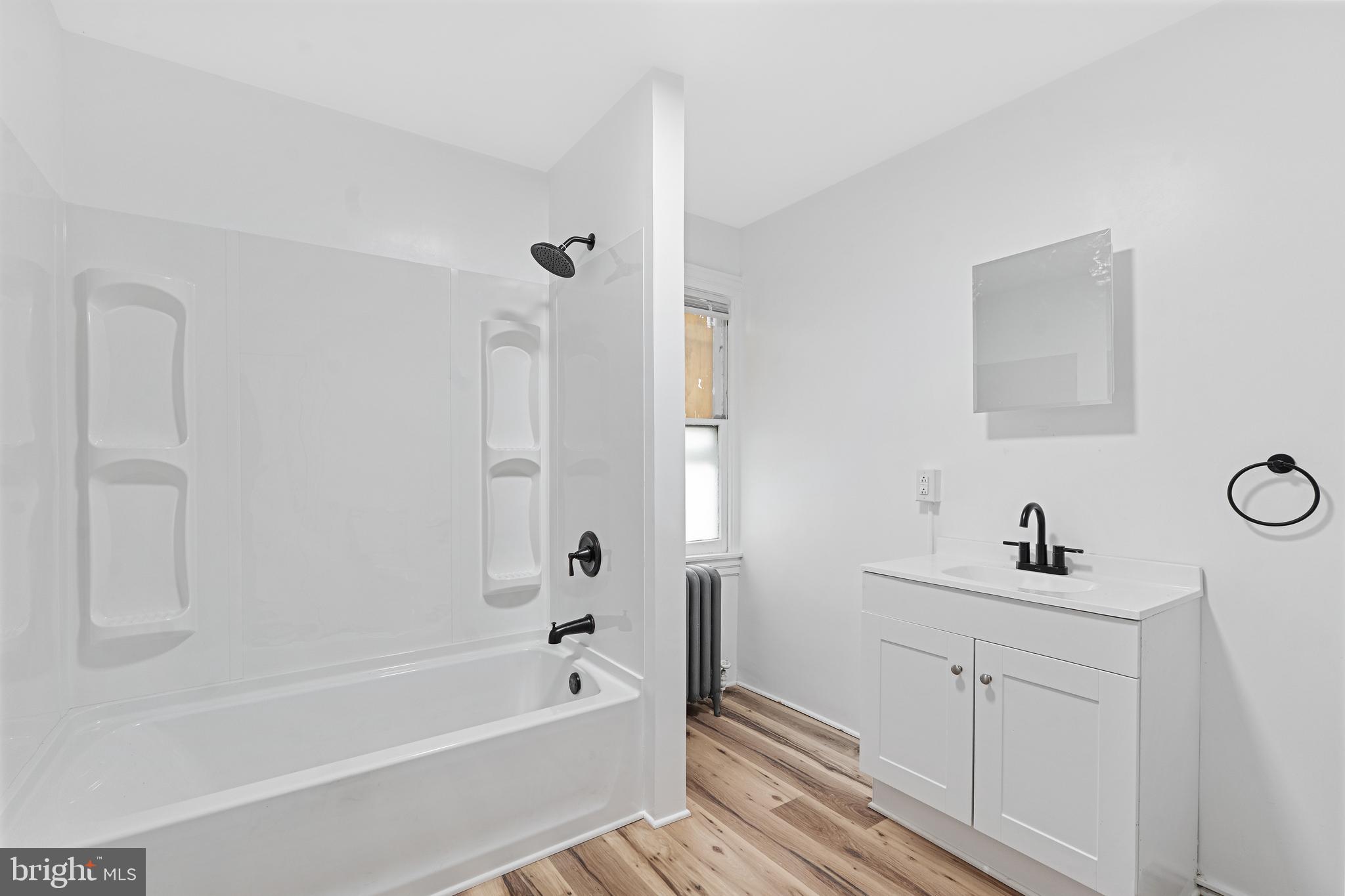 154 7th Street Salem, NJ 08079 - Photo 27 of 48 a bathroom with a tub sink and mirror