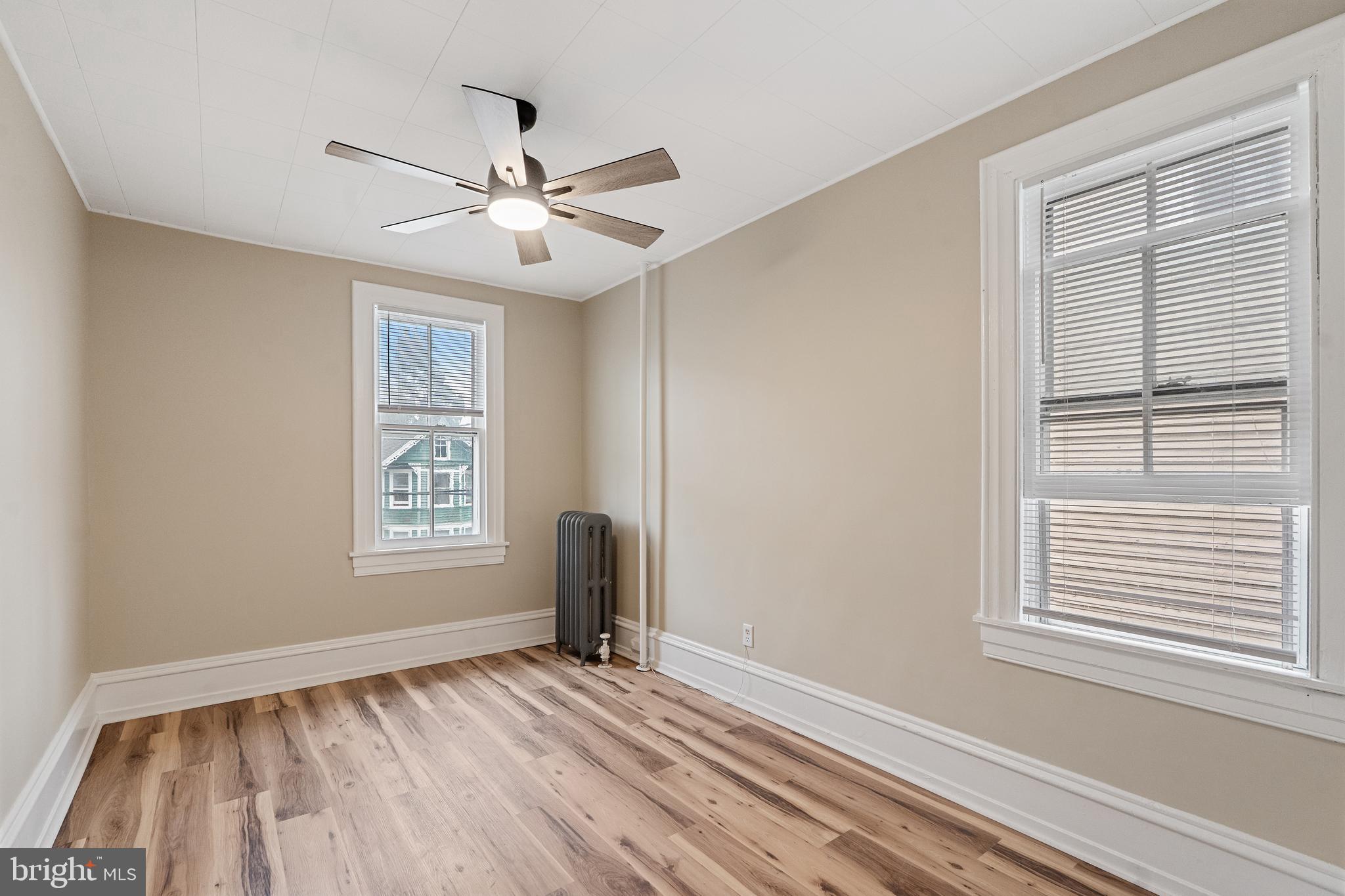 154 7th Street Salem, NJ 08079 - Photo 32 of 48 a view of an empty room with a window and wooden floor