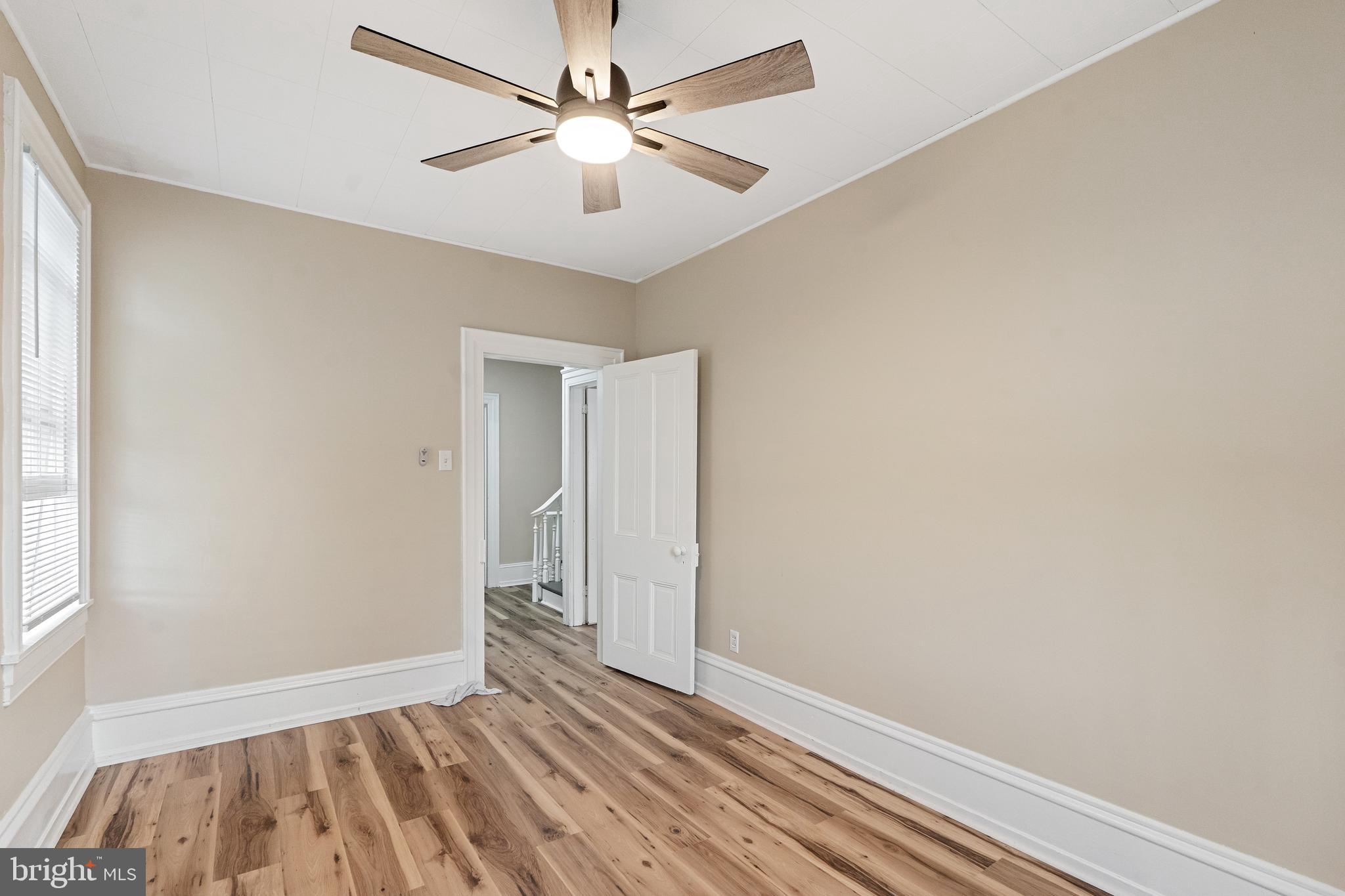154 7th Street Salem, NJ 08079 - Photo 33 of 48 wooden floor in an empty room with a window