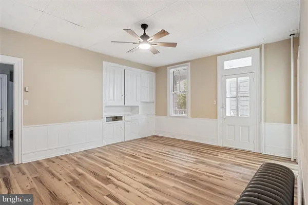 a view of a bedroom with wooden floor and closet